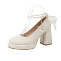Women's beige Mary Jane shoes with ankle strap buckle, chunky low heel, pearl detail and round toe.