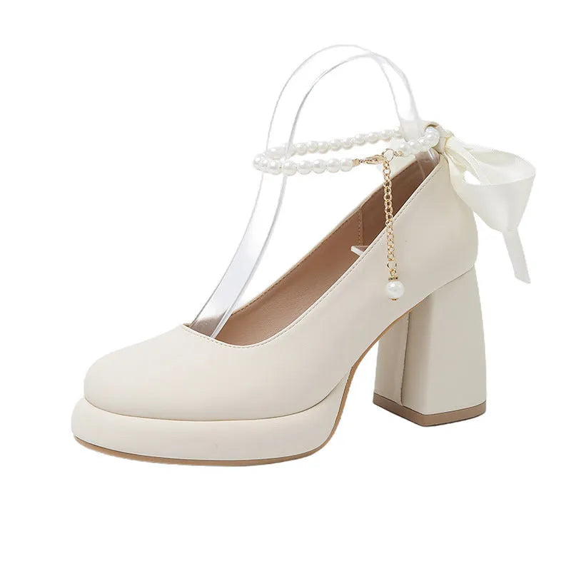 Women's beige Mary Jane shoes with ankle strap buckle, chunky low heel, pearl detail and round toe.
