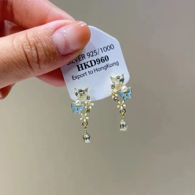 Geometric heart-shaped women's earrings with rhinestones, star charms and a dangling tassel.