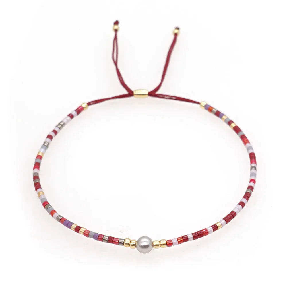 Handmade colourful beaded bracelet with semi-precious stones in bohemian geometric design.