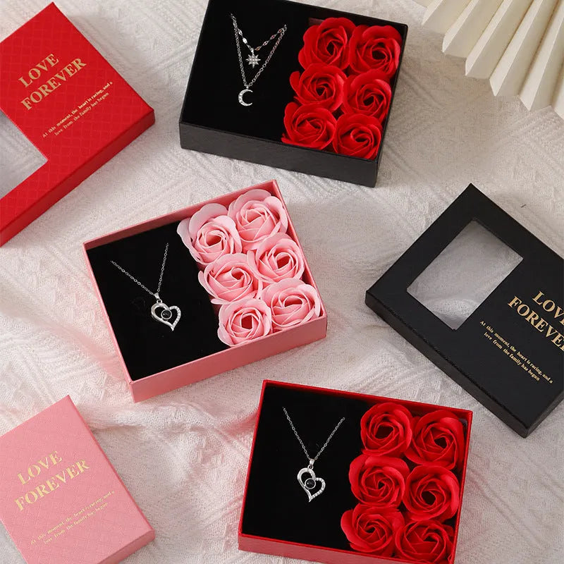 Six red soap flower roses in a black gift box with decorative handbag for Valentine's Day presents.