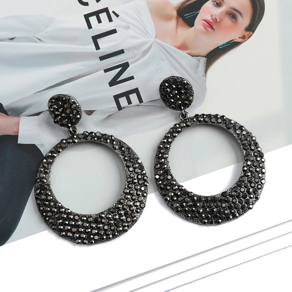Large round metal pendant earrings with diamond accents in cartoon style for women