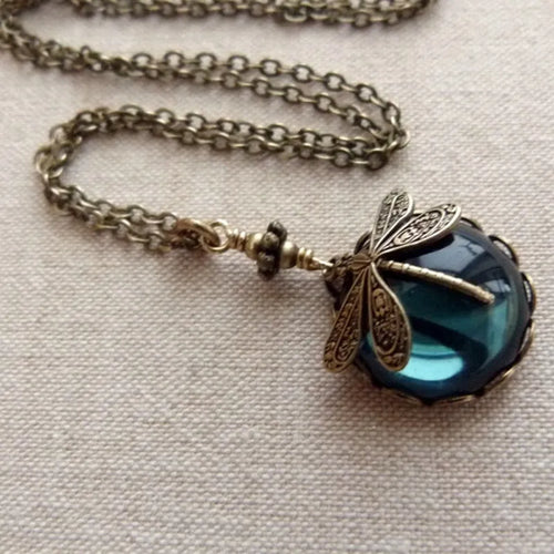 Hand-carved dragonfly pendant necklace in yellow bronze finish on a 925 silver chain.