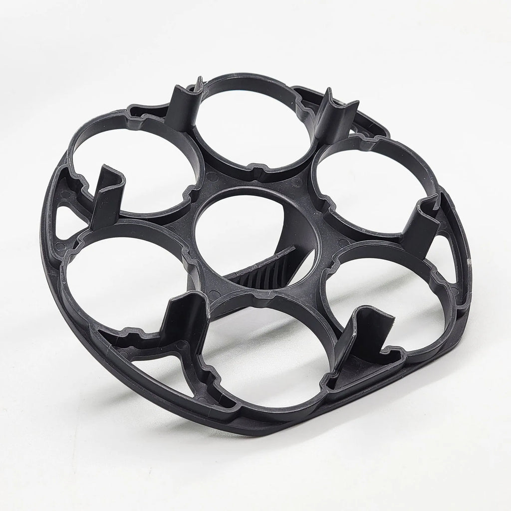 A black plastic egg holder rack on a kitchen countertop.