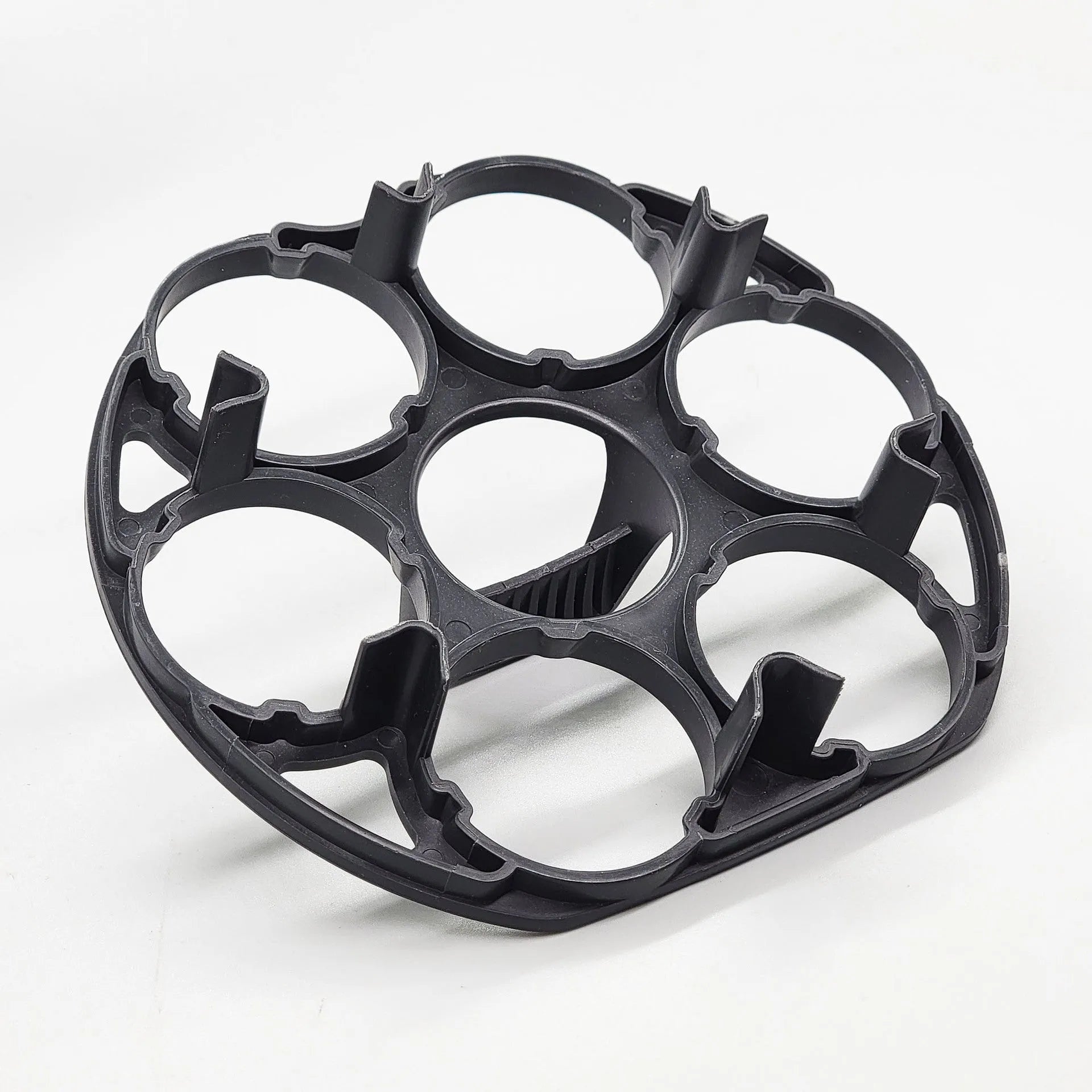 A black plastic egg holder rack on a kitchen countertop.
