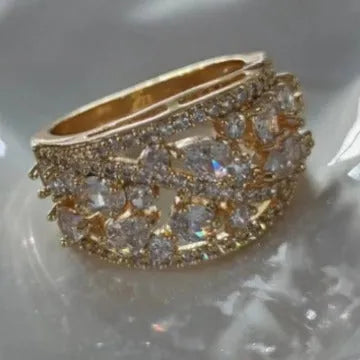 Women's hollow round copper fashion ring showing gold and platinum finish options with white and blue stone effects