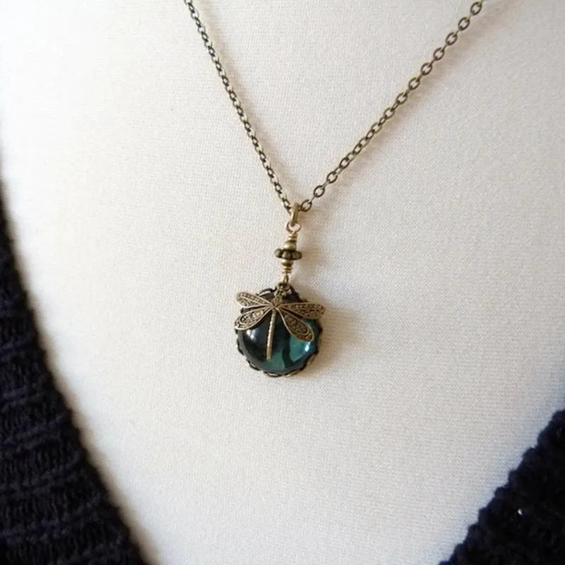 Hand-carved dragonfly pendant necklace in yellow bronze finish on a 925 silver chain.