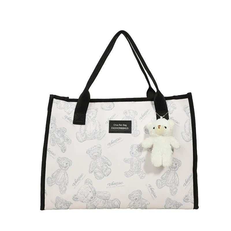 Women's black and white canvas tote bag with diamond pattern and sandwich pocket