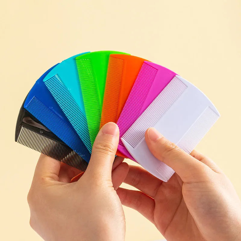 Double-edged fine-toothed plastic comb in assorted colours on a white background.