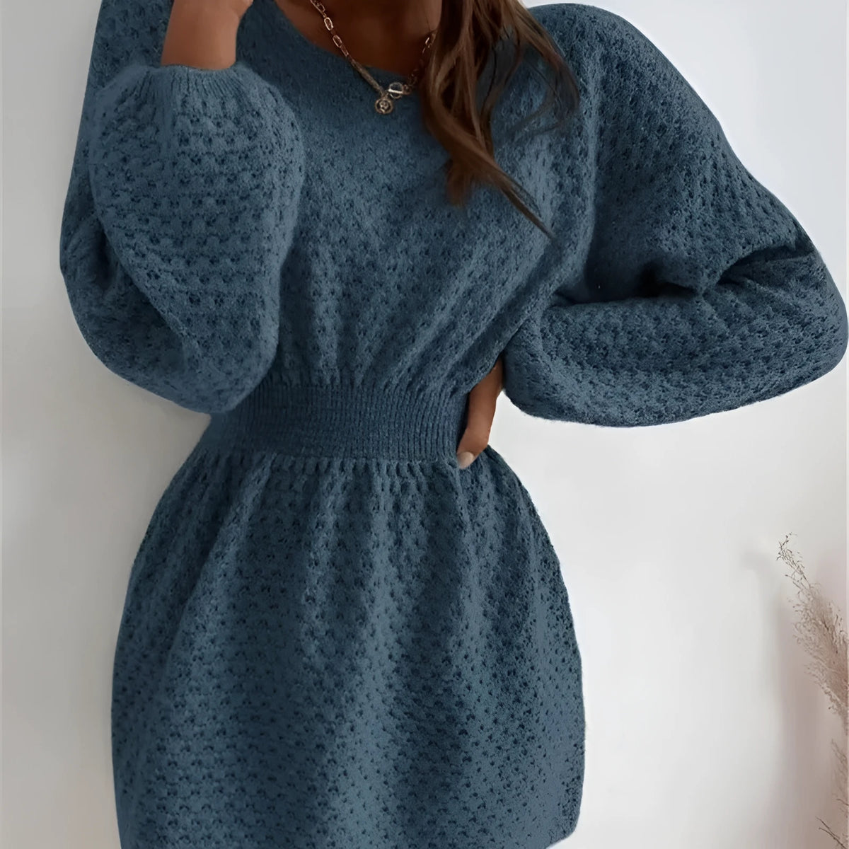 Blue women's knitted dress with hand crocheted floral details and fitted waist