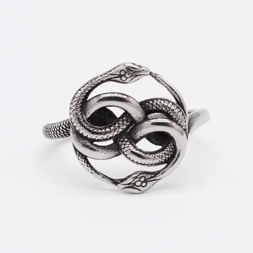 Close-up of a titanium steel double snake ring in a steel colour on a hand.