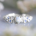 Women's peach-toned alloy heart ring with floral opal ocean pattern, shown in heart silhouette