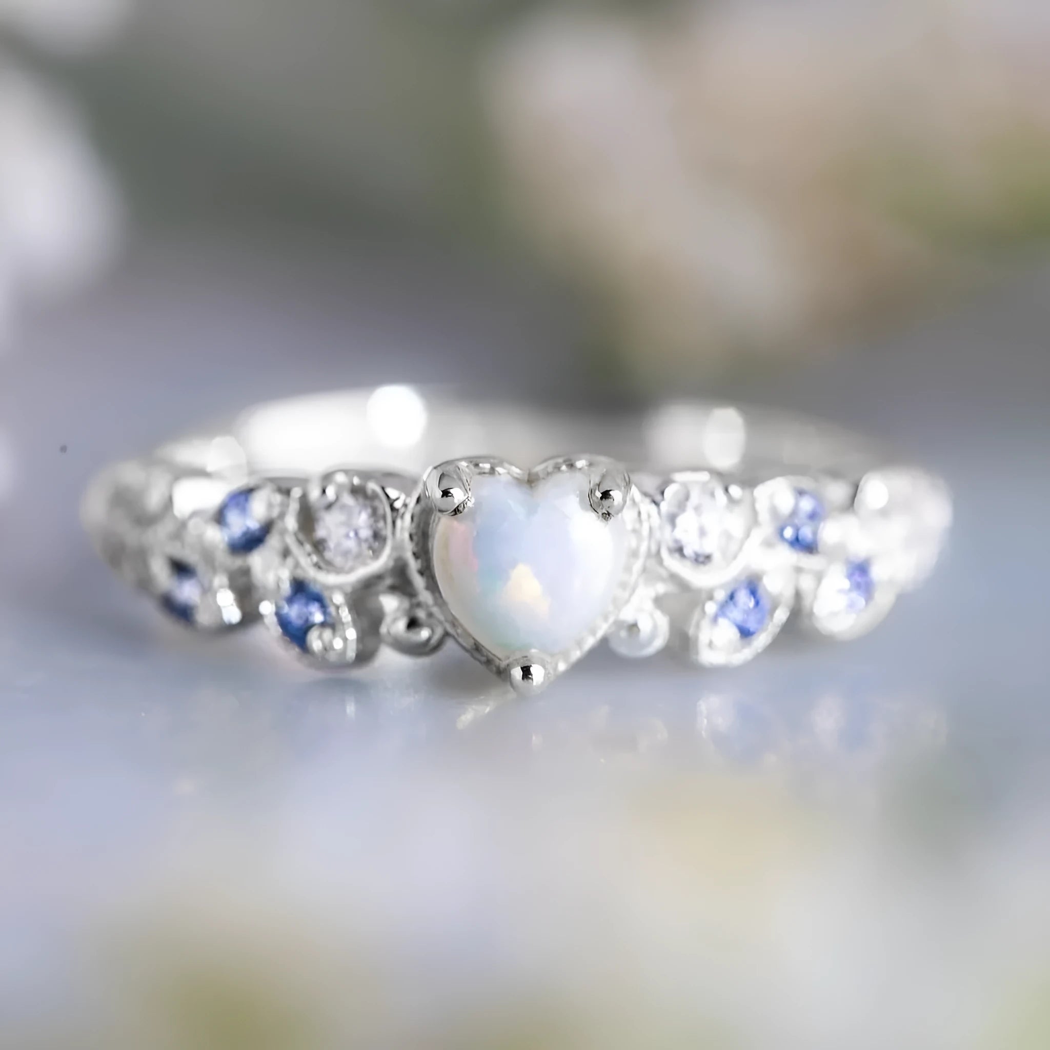 Women's peach-toned alloy heart ring with floral opal ocean pattern, shown in heart silhouette