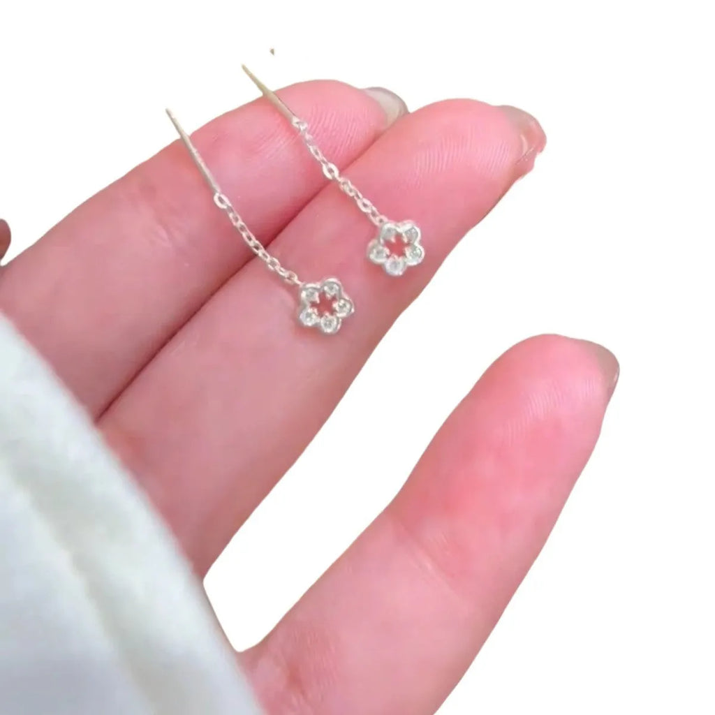 Silver hollow flower hanging earrings with petal design and sterling silver needle