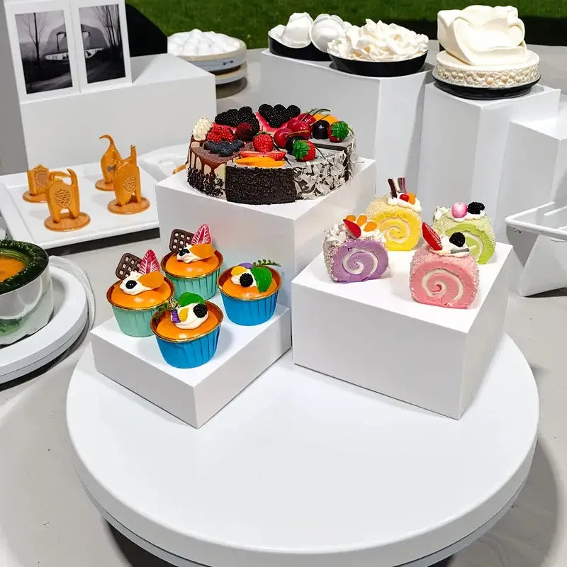 White plastic cube dessert display stand with stackable units for tiered cake and pastry presentation