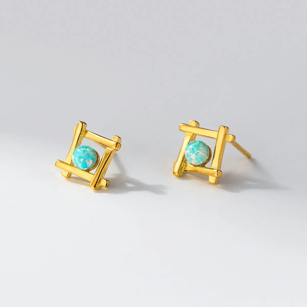 Women's geometric cross-shaped quadrangle stud earrings in sterling silver on a white background.