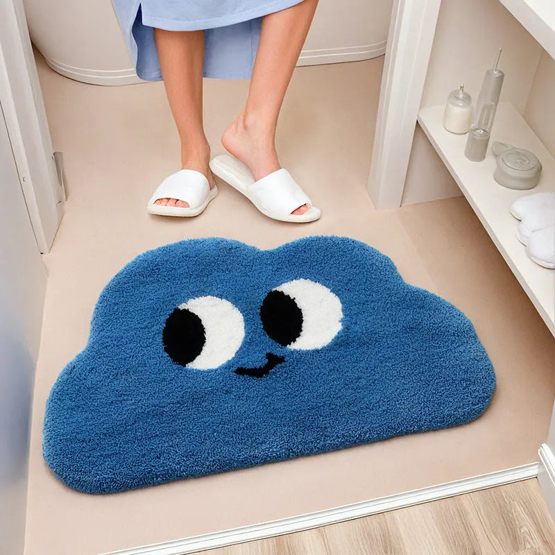 Cartoon anime Big Eye Clouds design bathroom mat in soft green colour on a bathroom floor.