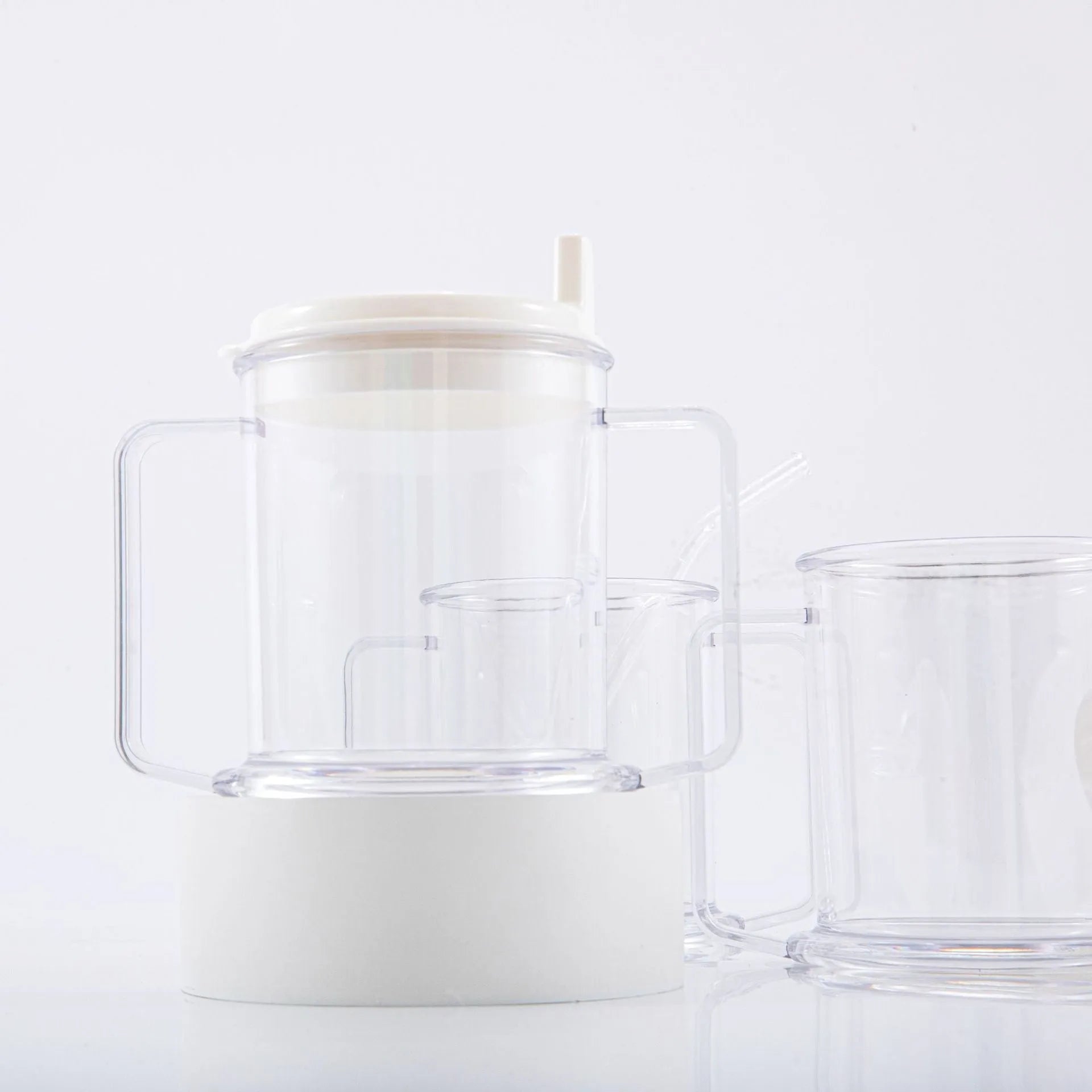 Transparent spill-proof drinking cup with lid on white background