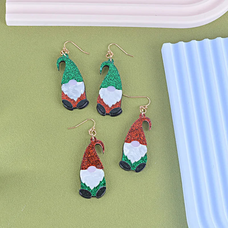 A pair of cartoon Santa Claus acrylic fashion earrings on a red background.