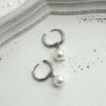 Pair of women's geometric pearl eardrops with titanium steel alloy and round elements in hip hop style