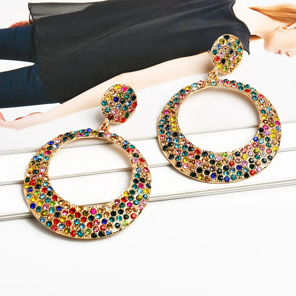 Large round metal pendant earrings with diamond accents in cartoon style for women