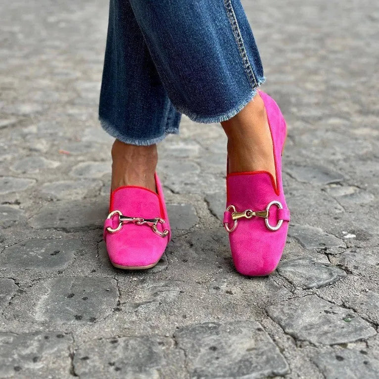 Women's green suede loafers with a round toe and silver metal fastener on the front.
