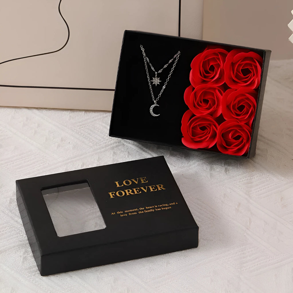 Six red soap flower roses in a black gift box with decorative handbag for Valentine's Day presents.