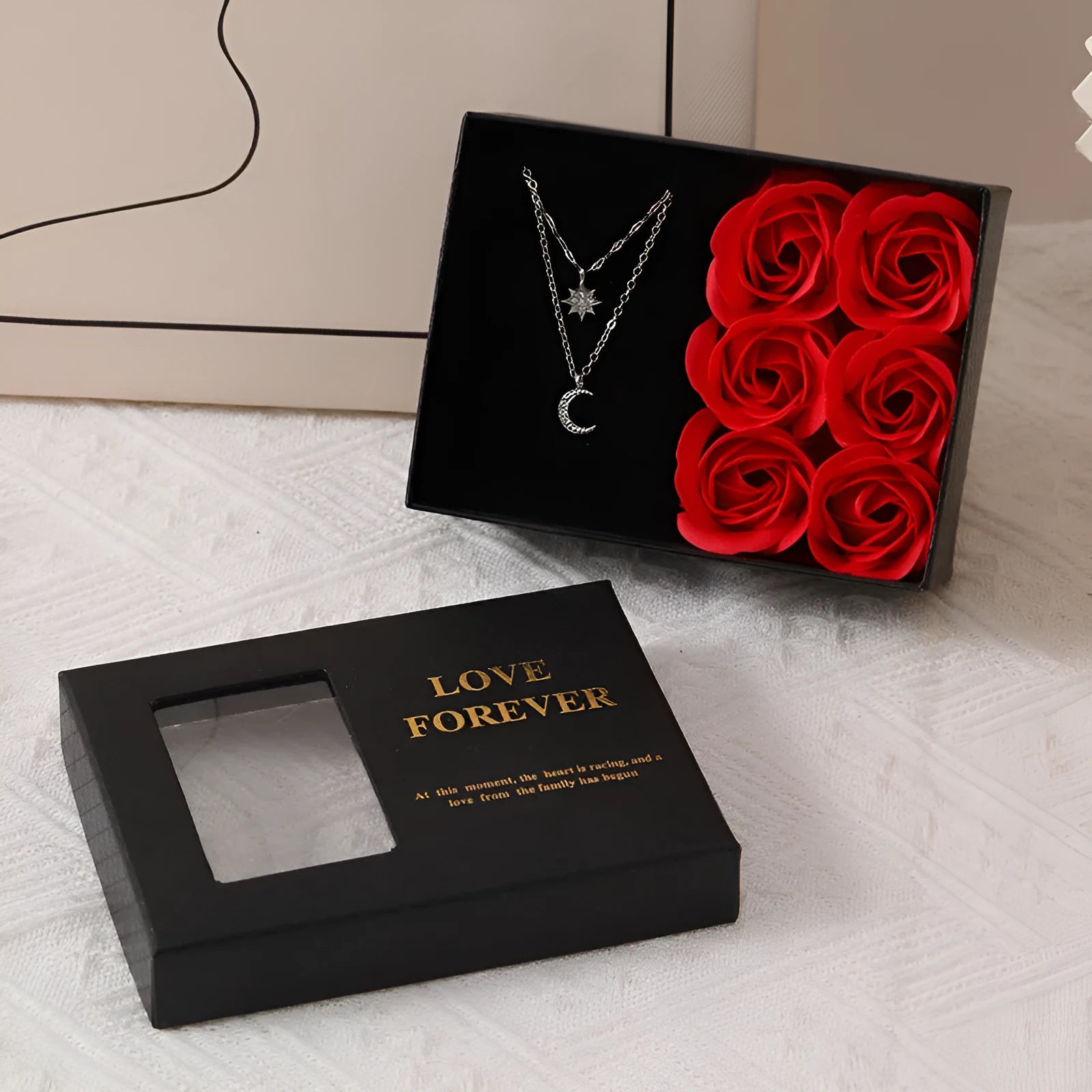 Six red soap flower roses in a black gift box with decorative handbag for Valentine's Day presents.