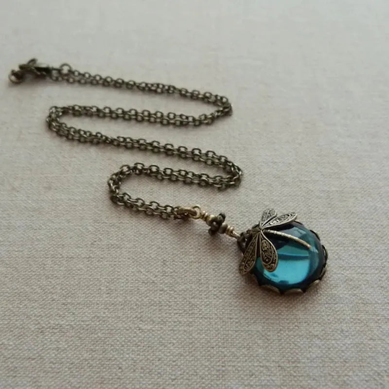Hand-carved dragonfly pendant necklace in yellow bronze finish on a 925 silver chain.
