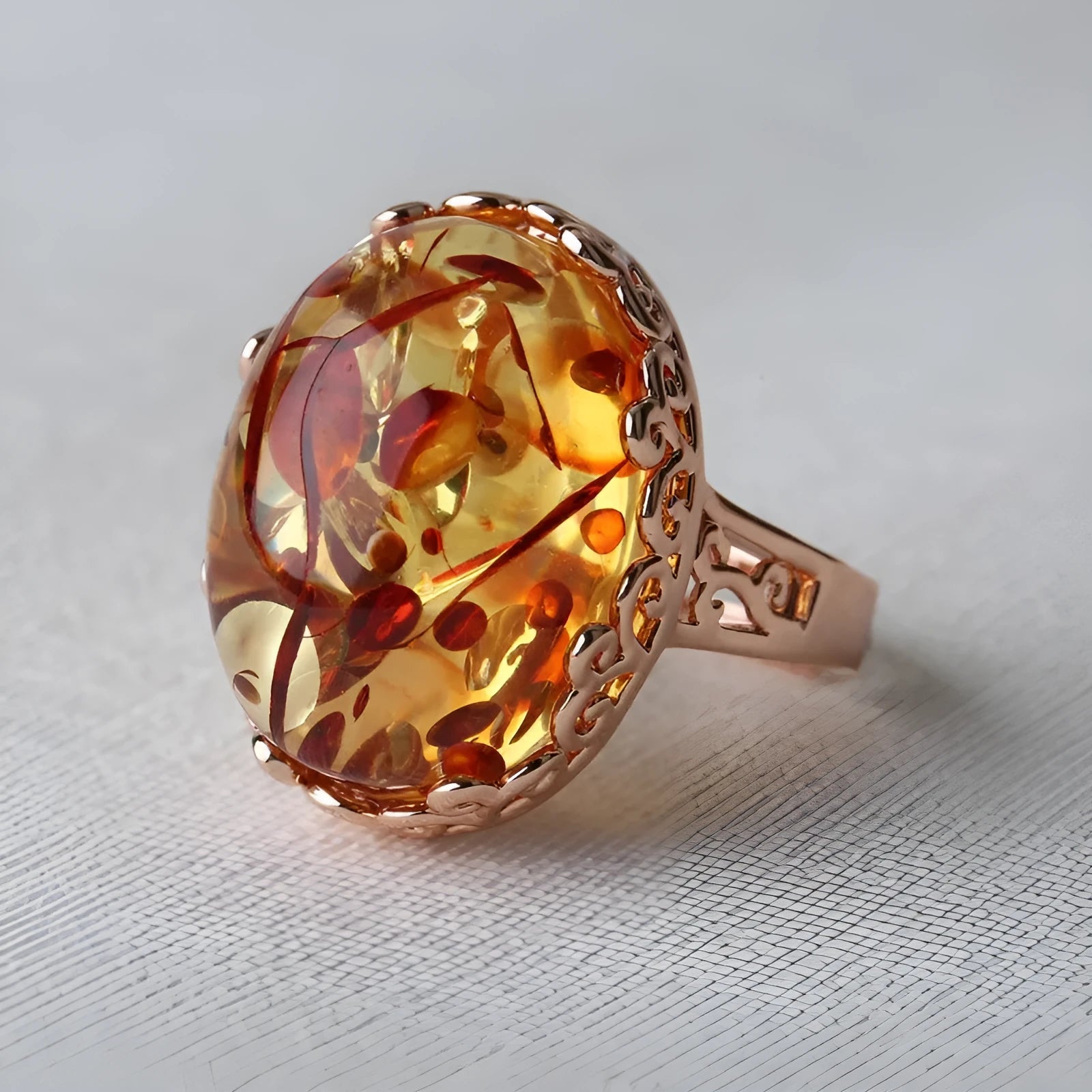 Close-up of an amber and beeswax ethnic style ring with an alloy base in a retro elegant design.