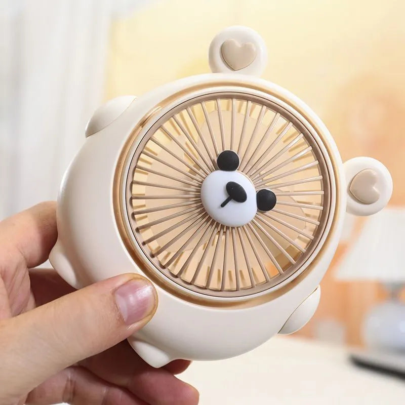 Cute dog-themed USB desktop electric fan in a choice of six colours on a wooden desk.