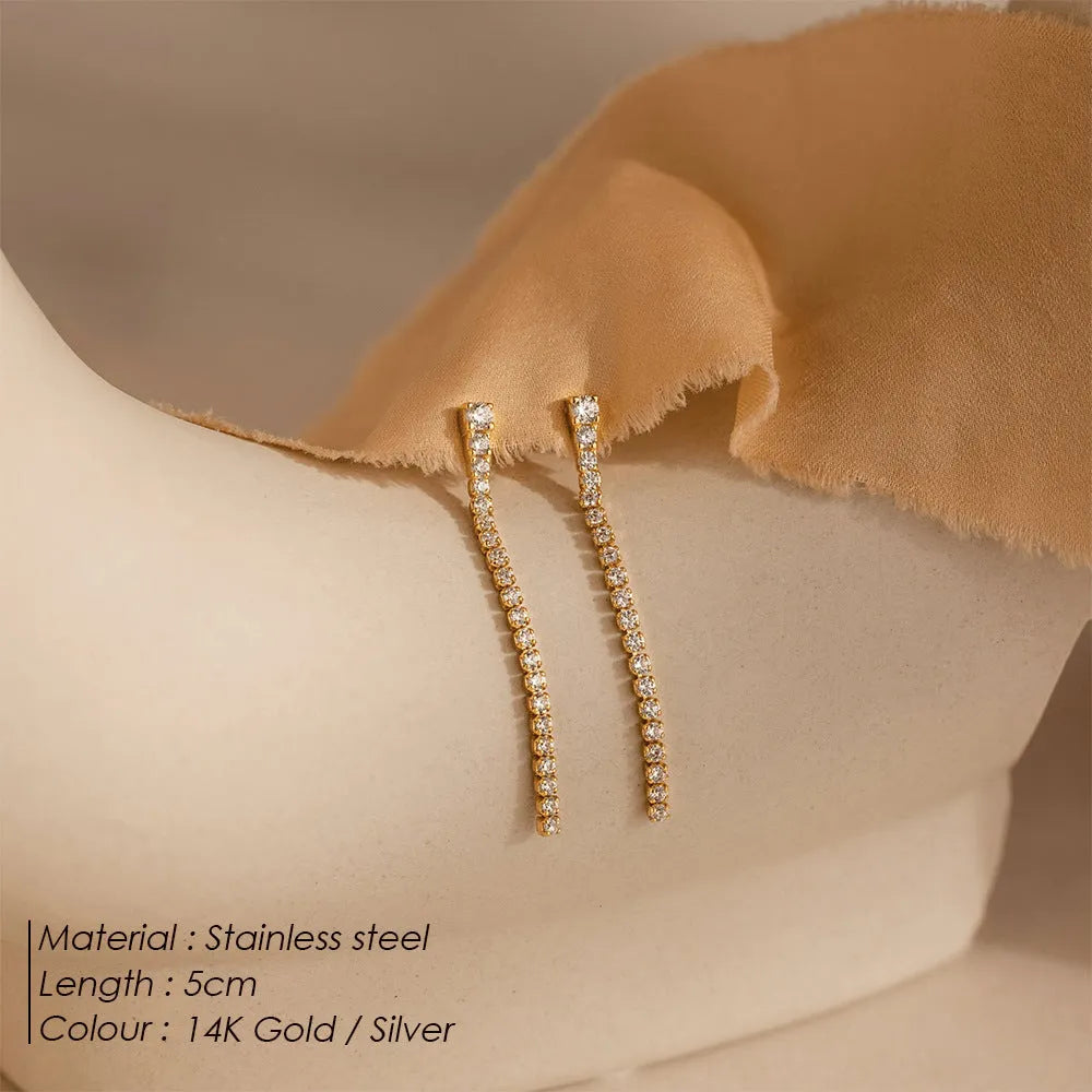 Geometric stainless steel zircon earrings in gold and steel colour on a white background.