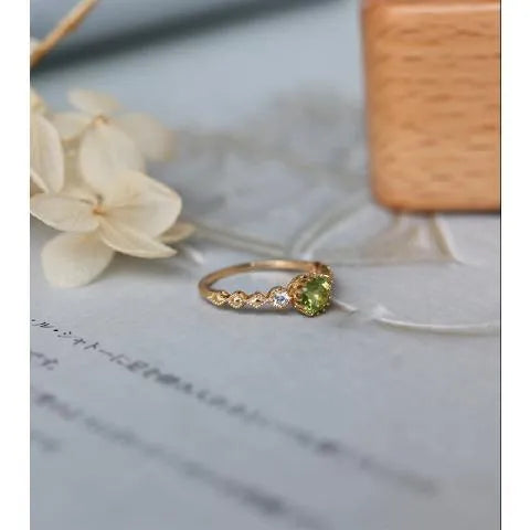 Japanese style copper ring with geometric quadrilateral shape and imitation peridot colour.