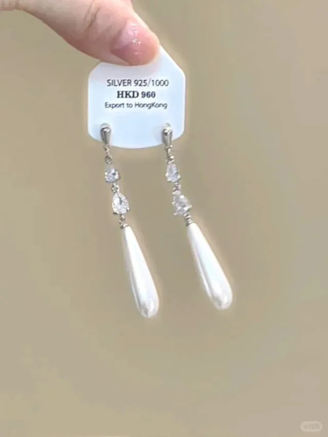 Geometric heart-shaped women's earrings with rhinestones, star charms and a dangling tassel.