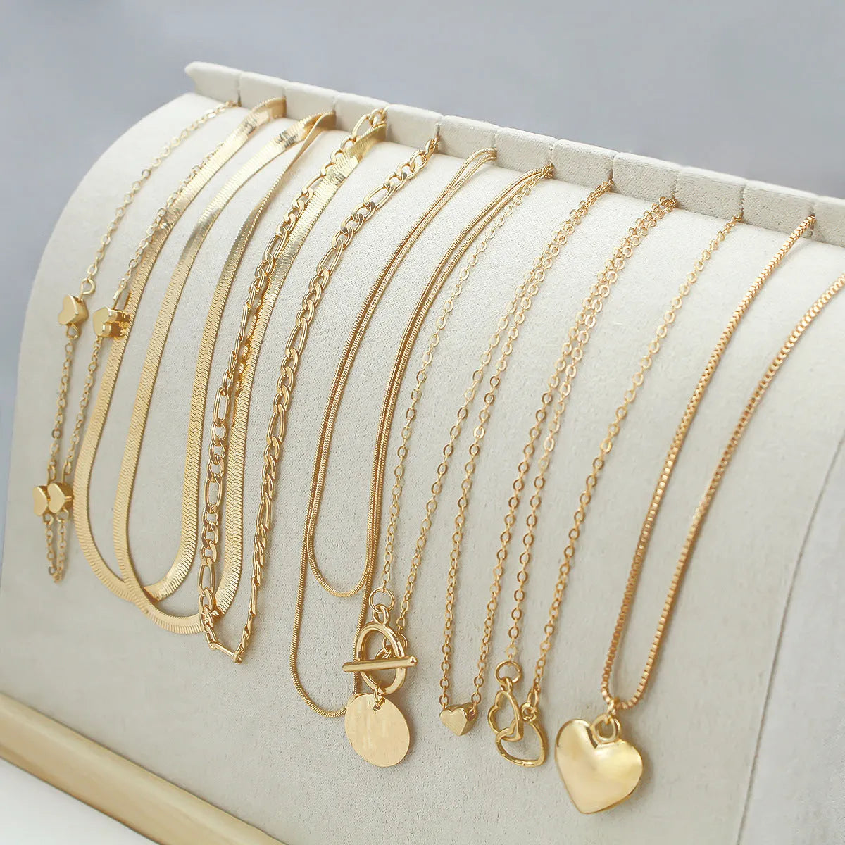 10-piece women's jewellery set with gold necklace featuring alloy pendant on snake bones chain