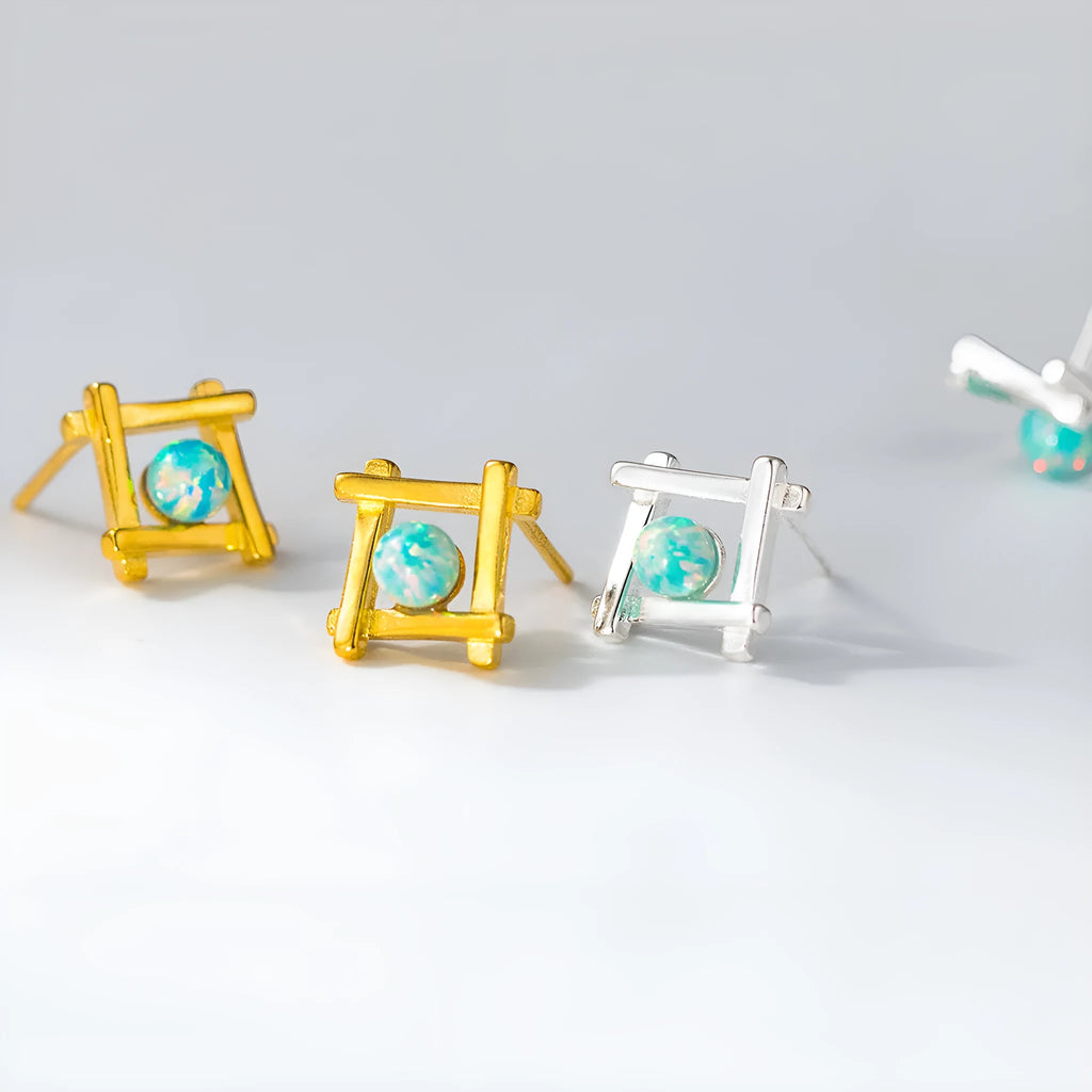 Women's geometric cross-shaped quadrangle stud earrings in sterling silver on a white background.