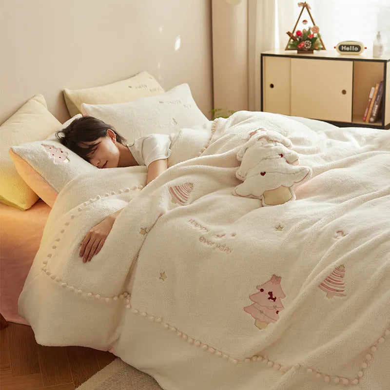 Winter milk fibre bedding four-piece set with green Christmas tree pattern on a bed.