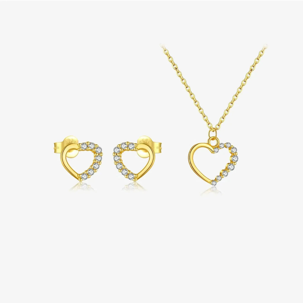 Close-up of a hollow heart-shaped sterling silver pendant on an oval chain, shown in both gold and white gold plated finishes.