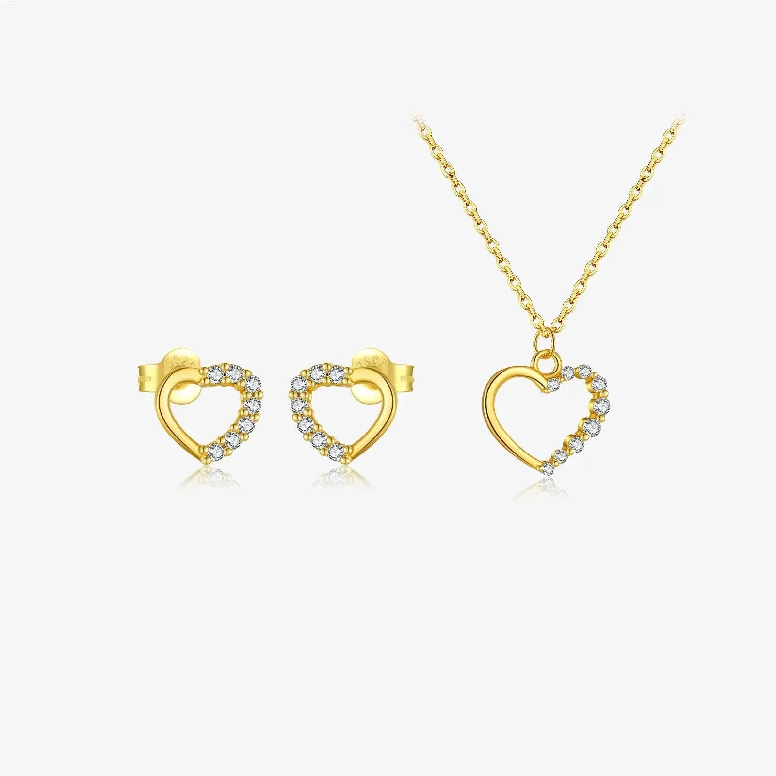 Close-up of a hollow heart-shaped sterling silver pendant on an oval chain, shown in both gold and white gold plated finishes.