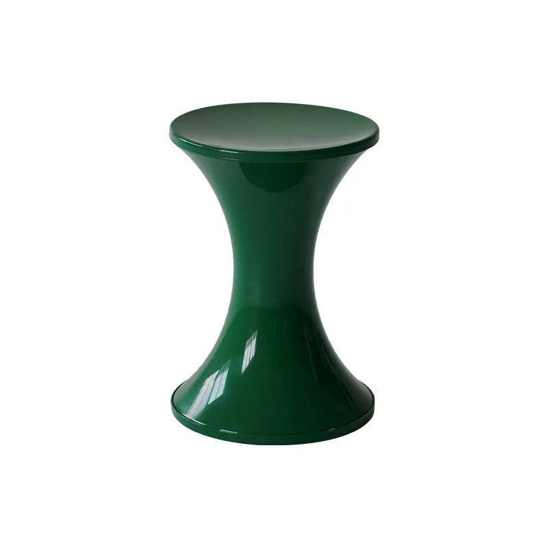 Plastic hourglass style shoe changing stool in green, shown in a home setting.