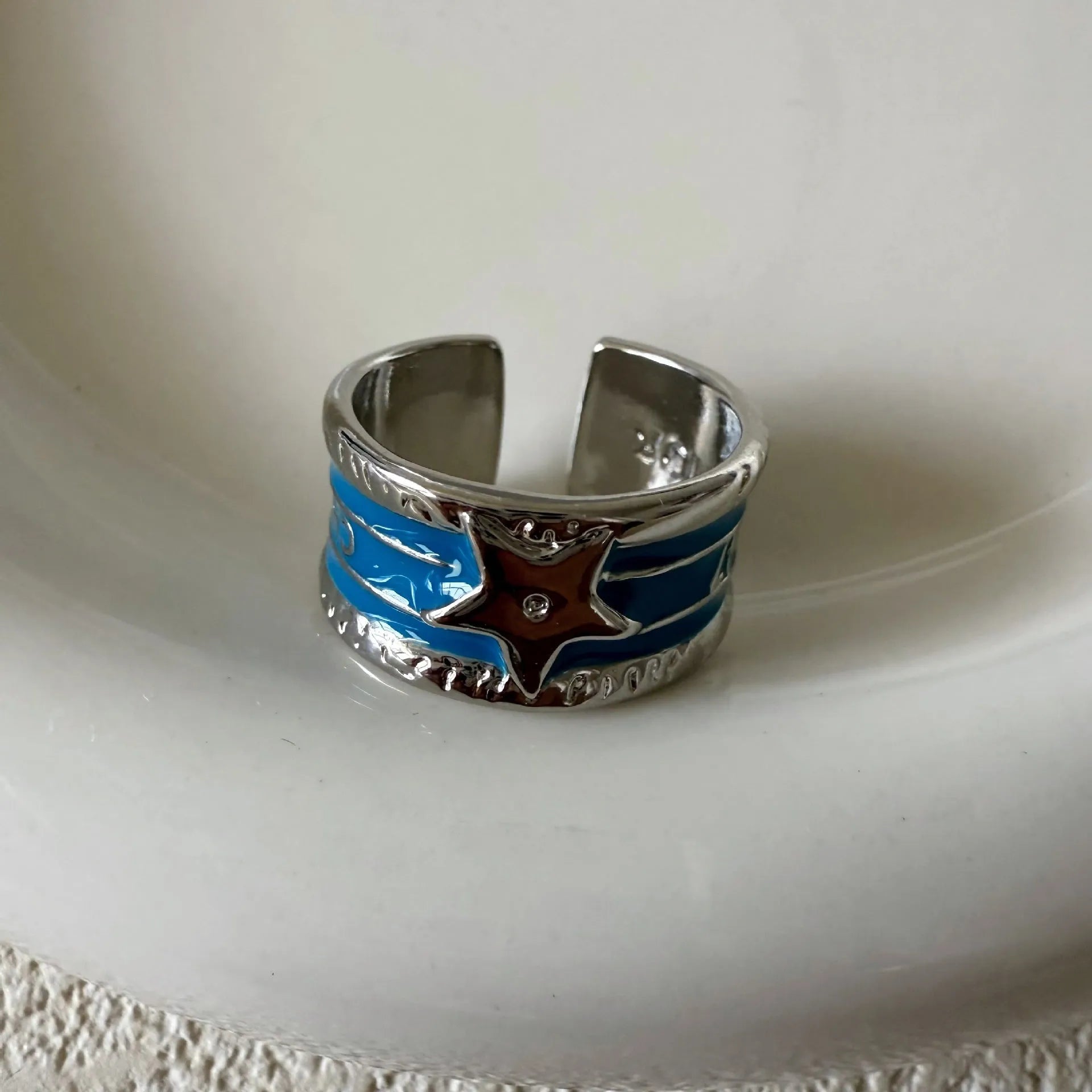 Adjustable geometric women's ring with a retro distressed XINGX drop oil design in copper.