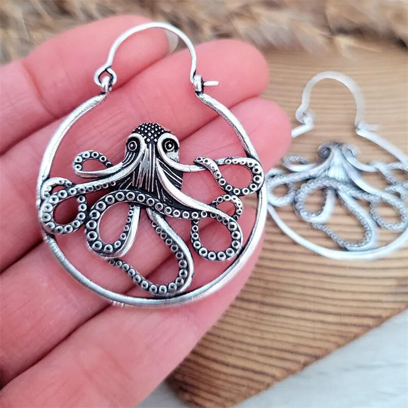 A pair of vintage-style octopus-shaped earrings in an antique silver colour.