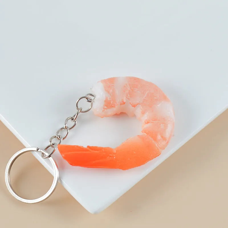 PVC simulation shrimp keychain on a key ring, showing its 1.5cm thickness and modern design.