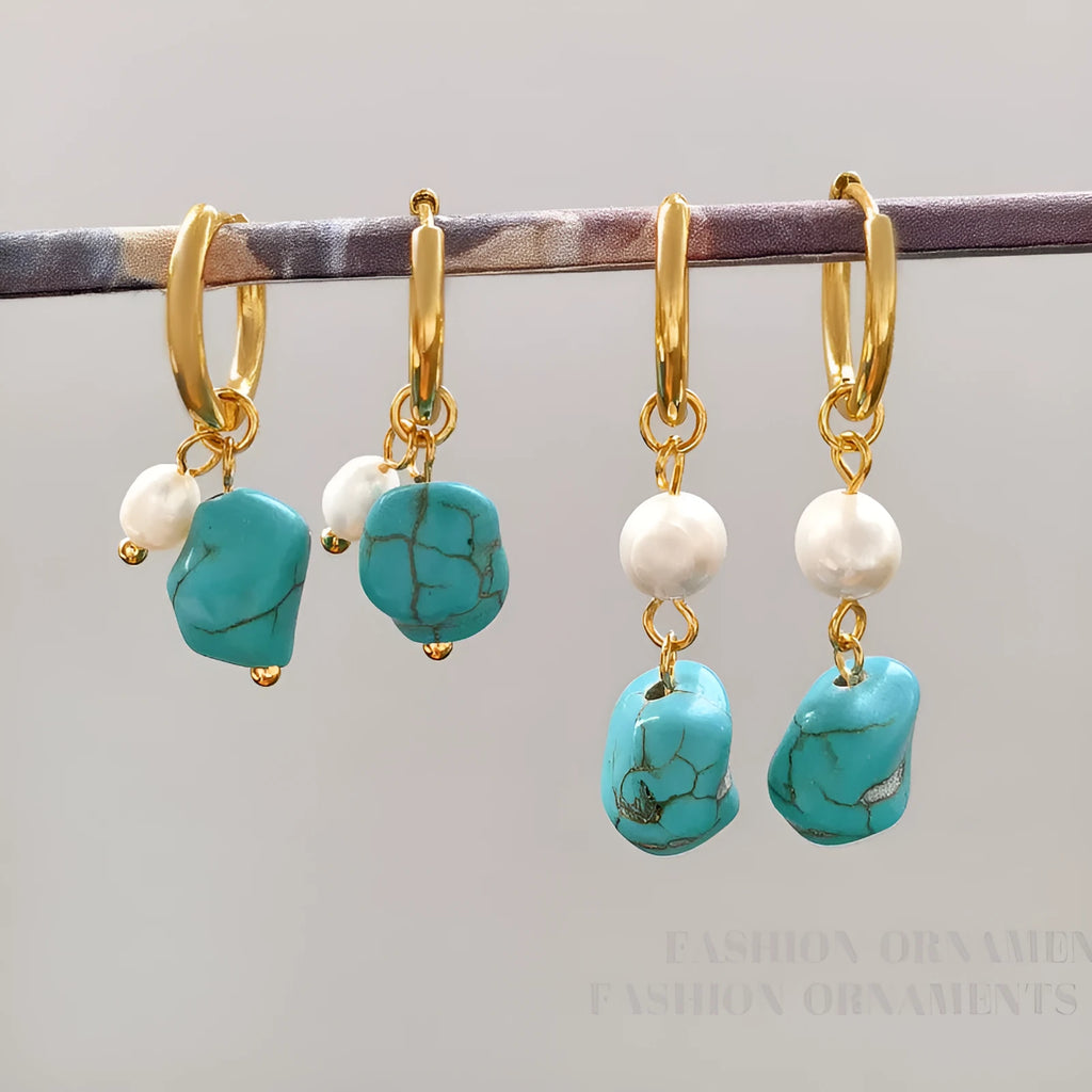 A pair of geometric turquoise and cultured pearl ear clips on a copper setting.