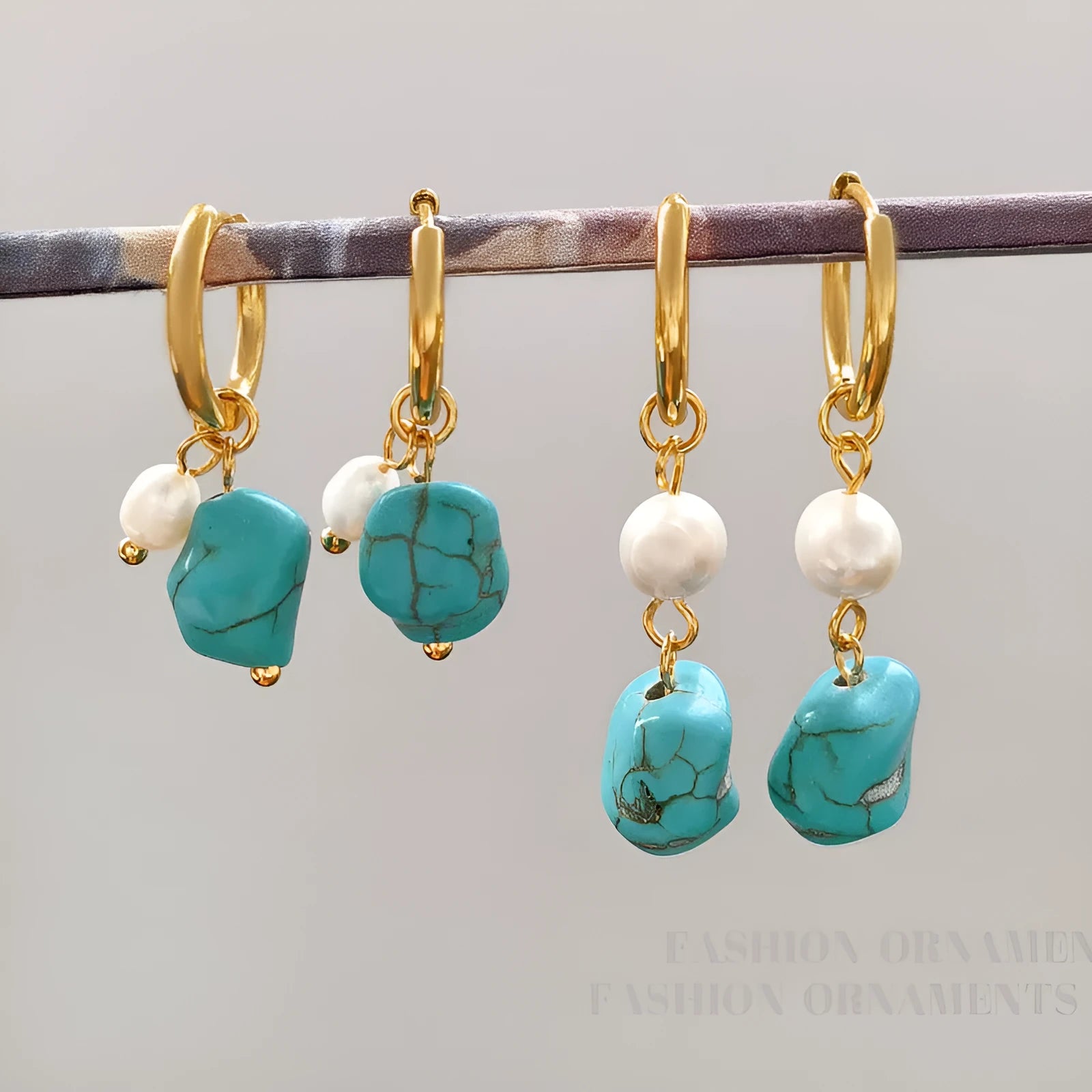 A pair of geometric turquoise and cultured pearl ear clips on a copper setting.