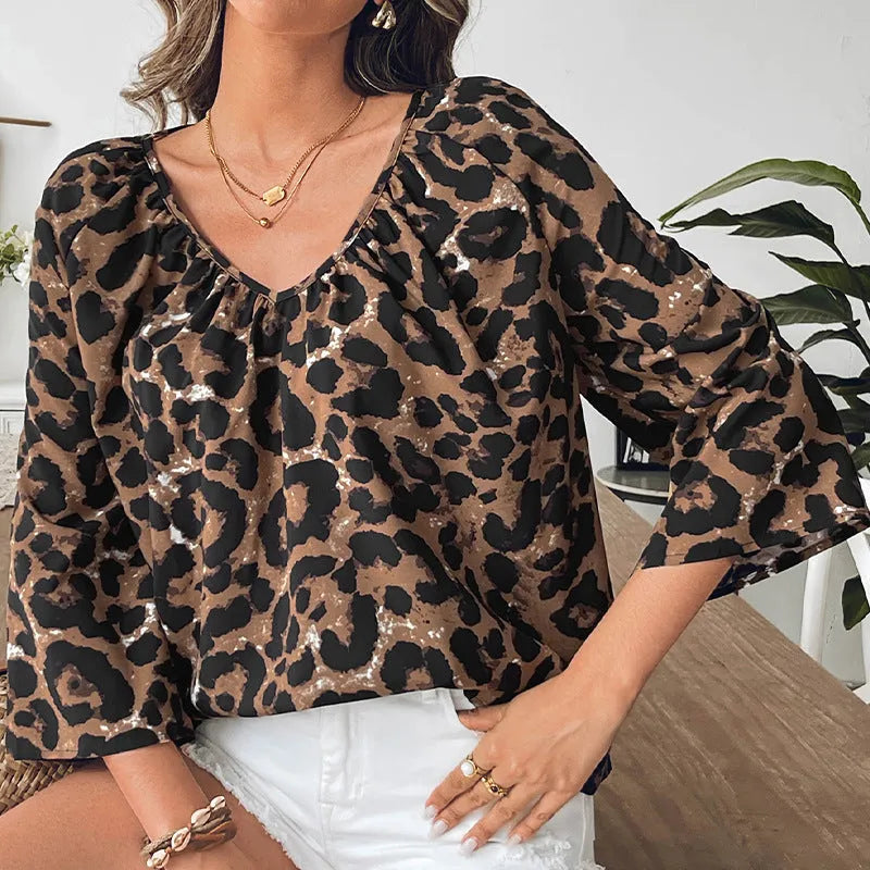 Women's leopard print V-neck pullover top with half sleeves and pleated detail