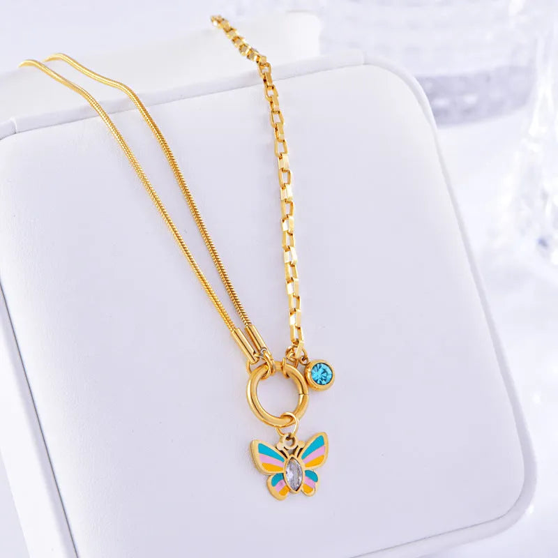 Gold colour epoxy butterfly jewellery set with titanium steel necklace and bracelet showing snake bones chain style