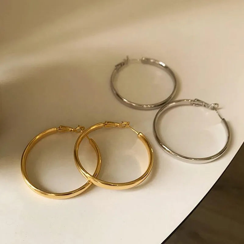 Metal circle earrings with gold or silver electroplated finish measuring 40mm diameter
