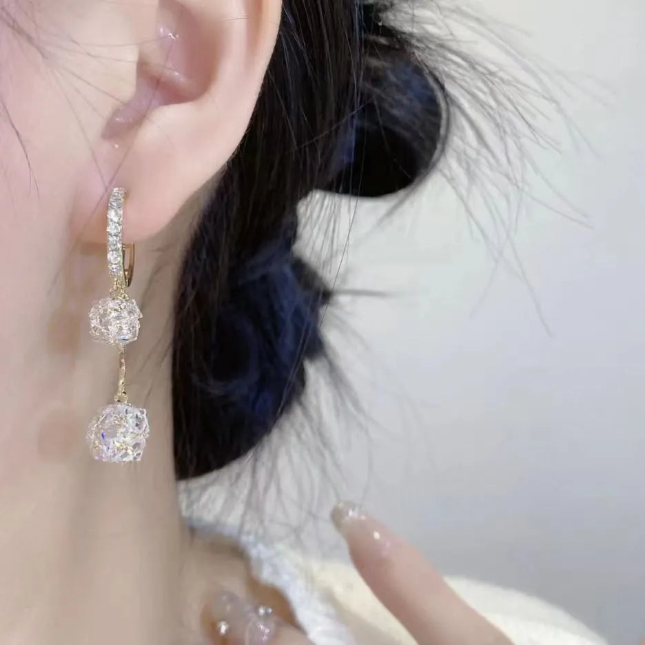 Silver drop earrings with a rhinestone ball and colourful balloon tassel pendant.