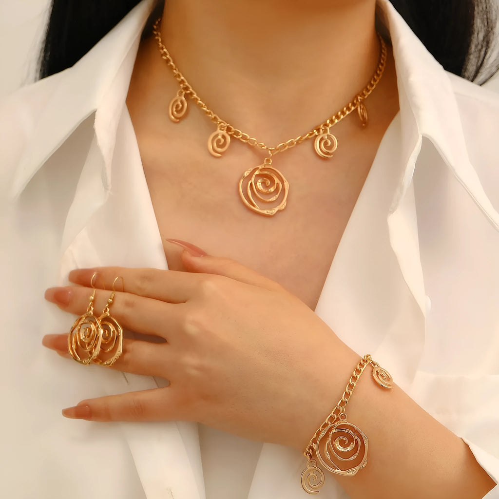 Spiral donut jewellery set showing necklace, bracelet and earrings in gold colour with geometry shapes